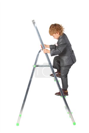 Boy in suit rises on step-ladder