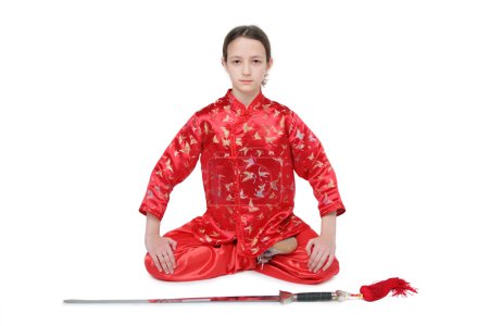 Wushu girl with sword sits
