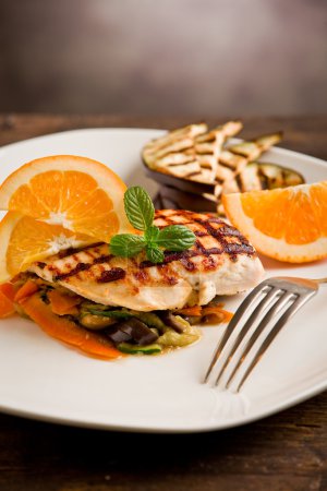 Grilled chicken breast on ratatouille bed
