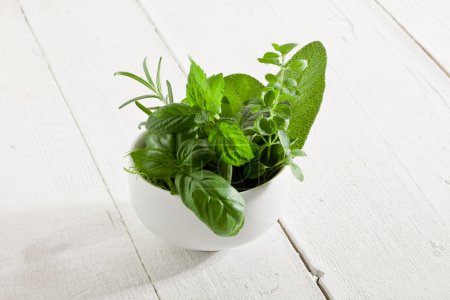 Herbs on white wooden table
