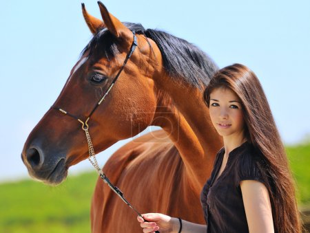Young girl and bay horse