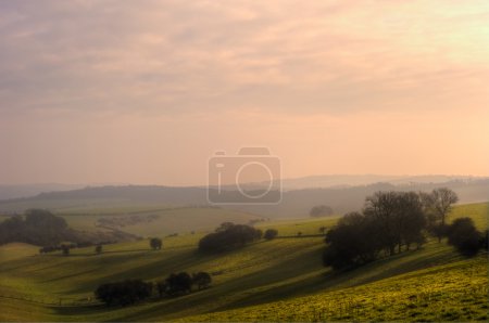 Rolling countryside landscape on hazy Summer evening