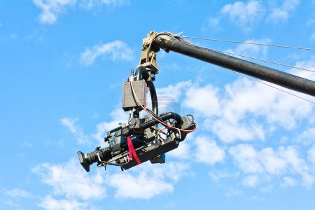 Tv camera on a crane against blue sky