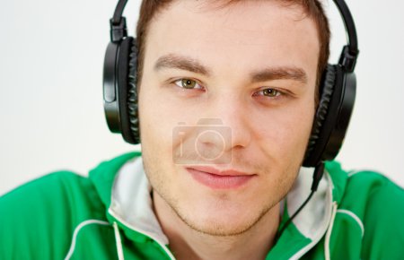 Portrait of a young man listen music with headphones