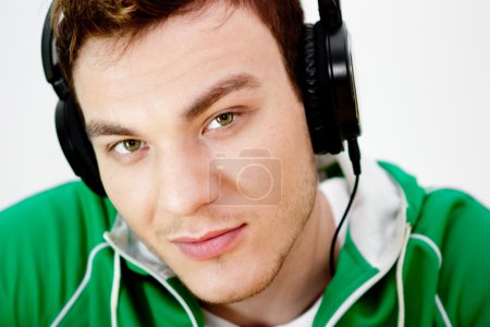 Portrait of a young man listen music with headphones