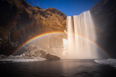 Rainbow at Skogafoss waterfall in winter, Iceland 
