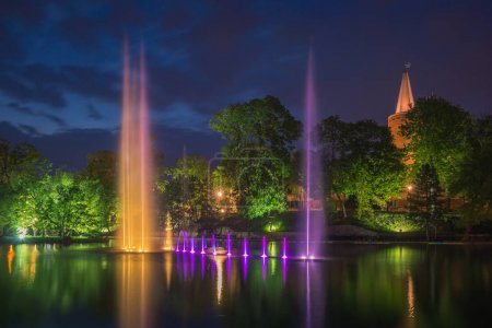 Piastowska tower and fountain in the castle pond at night in Opo
