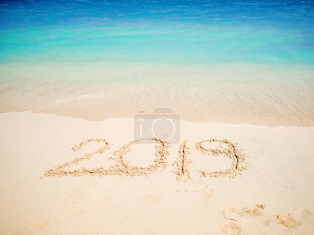 New 2019 year in the South, the sea. Inscription on the sand, celebrate the new year in the tropics. New year holidays