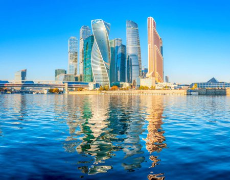 Panorama of the skyscrapers of the business center of Moscow from the embankment of the Moscow River, the reflection of buildings in the river, Moscow, Russia