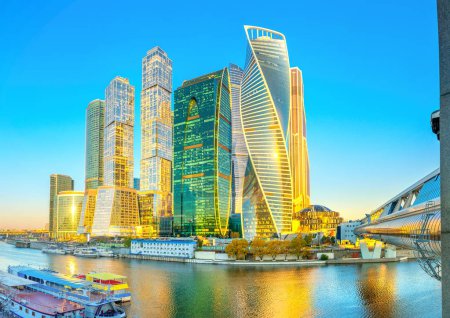 Panorama of the skyscrapers of the business center of Moscow from the embankment of the Moskva River at sunrise, reflection, Moscow, Russia