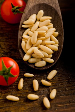 Pine nuts on wooden spoon