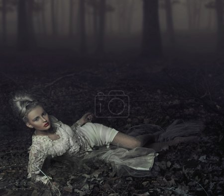 Blond beauty laying on leaves