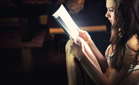 Attractive woman reading a book
