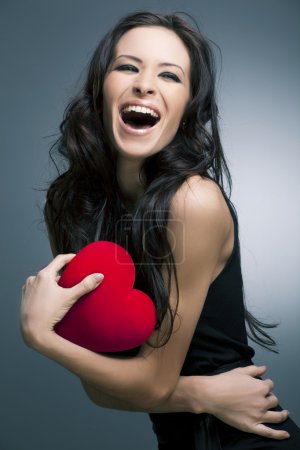 Valentines Day. Beautiful smiling woman with a gift