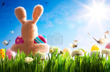Art Easter teddy bunny and Easter eggs on green grass