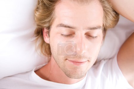 Young Man Sleeping In His Bed