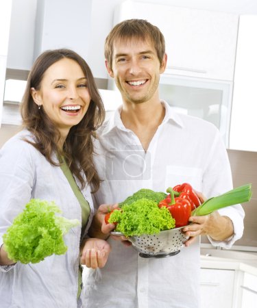 Young Couple Cooking Healthy food.Diet.Kitchen