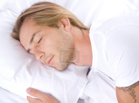 Young Man Sleeping In His Bed