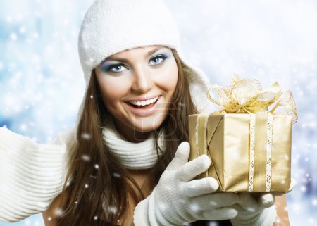 Beautiful Happy Girl with Christmas Gift. Snow