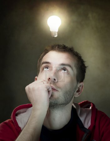 Young Man Having An Idea. Light Bulb Above His Head