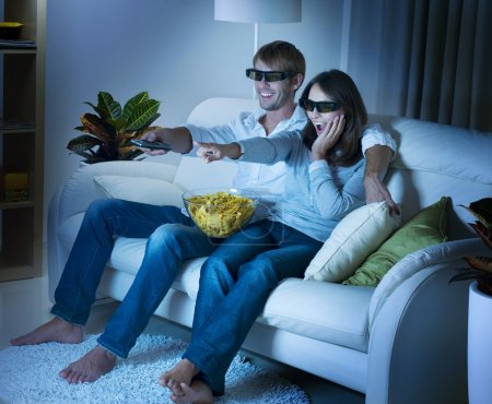 Family watching 3D film on TV