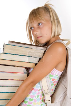 Back To School. Little Schoolgirl With Heavy Books