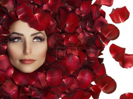 Beautiful Woman's Face and rose petals. Perfect Skin