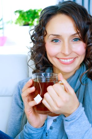 Beautiful Young Woman drinking hot tea