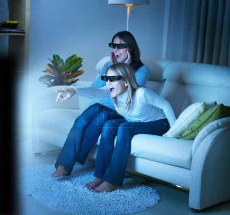 Mother with Daughter watching 3d film on TV