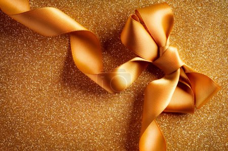 Holiday Background.Greeting Card.Gold Bow on a Blinking Backgrou