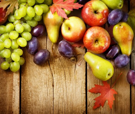 Organic Fruits over wood background. Autumn harvest