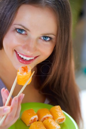 Beautiful Young Woman Eating Sushi. Diet