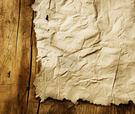 Old Paper sheet over wooden background closeup