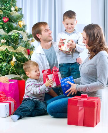 Happy Big family holding Christmas presents at home.Christmas tr