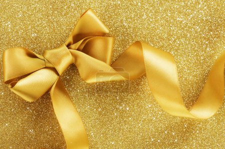 Holiday Background.Greeting Card.Gold Bow on a Blinking Backgrou
