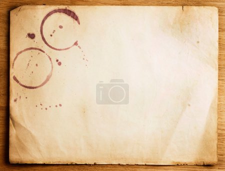 Old Paper Sheet With Stains Over Wooden Background