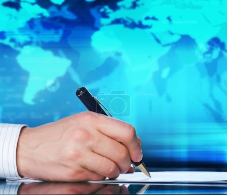 Businessman's hand with a pen. International business concept