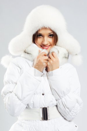 Beautiful woman in white winter clothing