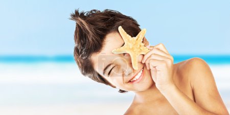 Happy face boy with starfish on the beach
