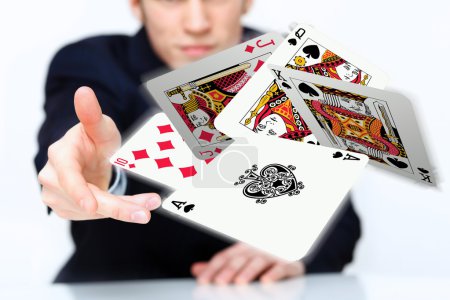 Young man showing poker cards