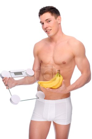 Man with bathroom scales and banana