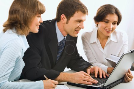 Business discuss an idea in front of the computer