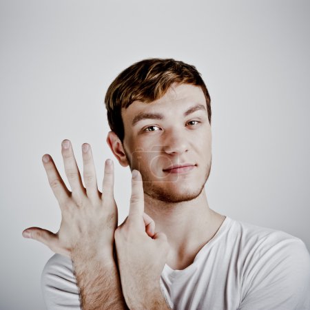 Young man holding up two fingers