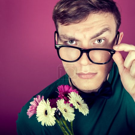 Portrait of a man in big glasses with flowers