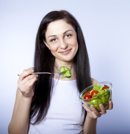 Portrait of a girl eating salad