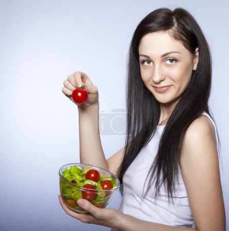 Beautiful girl with vegetable salad