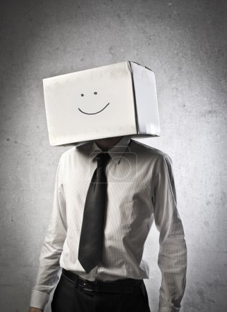 Young businessman wearing a carton with a smiley face on it