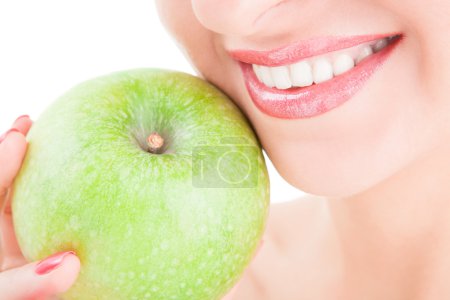 Healthy teeth and green apple