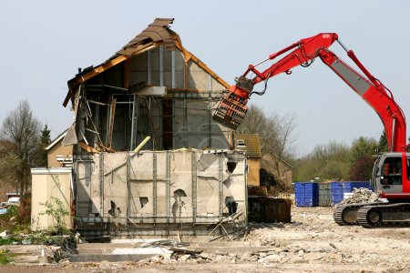 Excavator demolishing a building