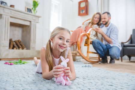 Girl playing with toy rabbit